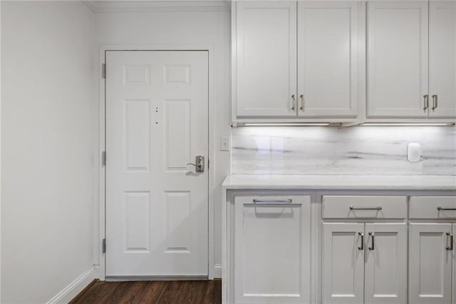 kitchen featuring white cabinetry and dark wood-type flooring