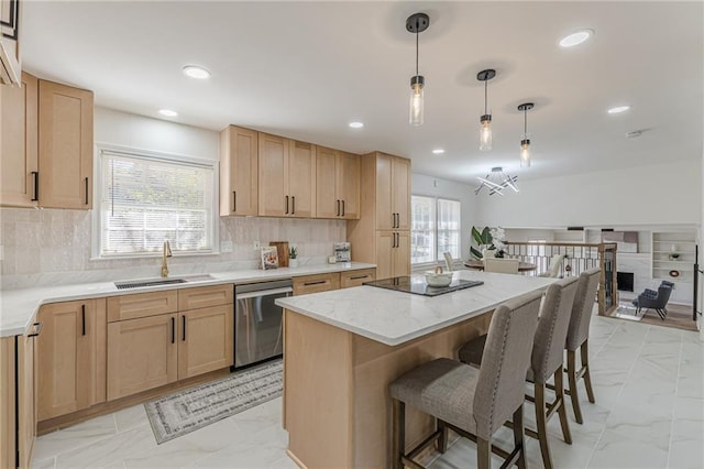 kitchen with stainless steel dishwasher, sink, hanging light fixtures, and light brown cabinetry