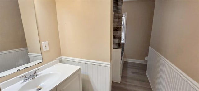 bathroom featuring hardwood / wood-style floors, vanity, and toilet