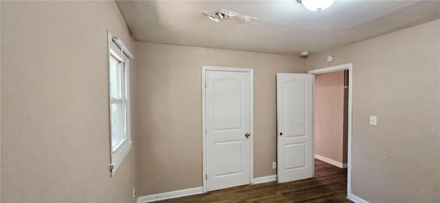 unfurnished bedroom featuring dark hardwood / wood-style floors