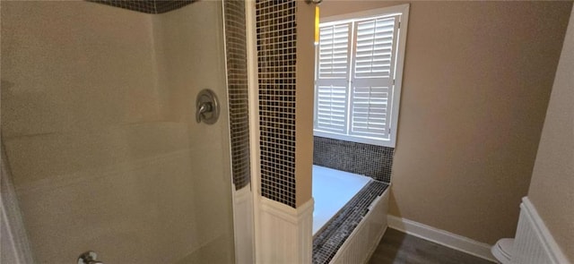 bathroom featuring separate shower and tub and toilet