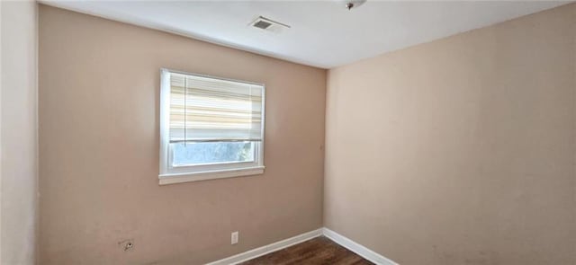 empty room with dark wood-type flooring