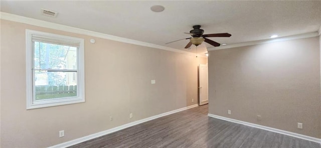 spare room featuring ceiling fan, ornamental molding, and dark wood-type flooring