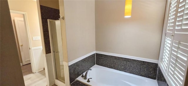 bathroom with plus walk in shower and wood-type flooring