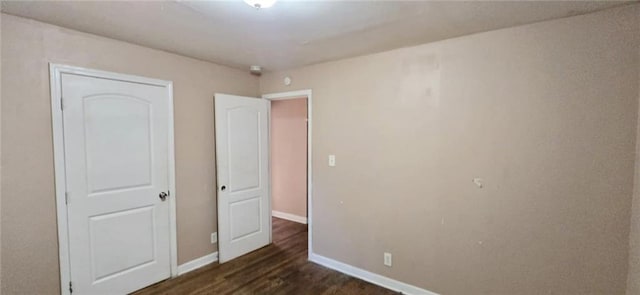 unfurnished bedroom featuring dark wood-type flooring