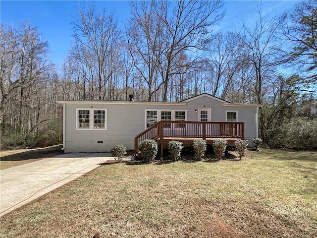 manufactured / mobile home with a front yard, crawl space, driveway, and a deck