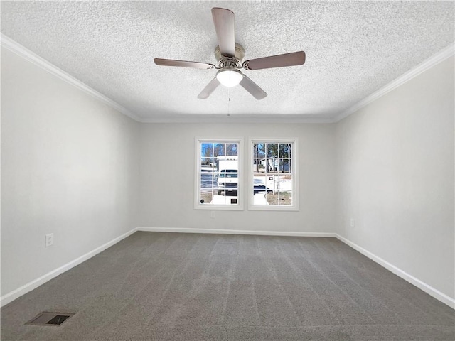 spare room with ornamental molding, dark carpet, visible vents, and baseboards