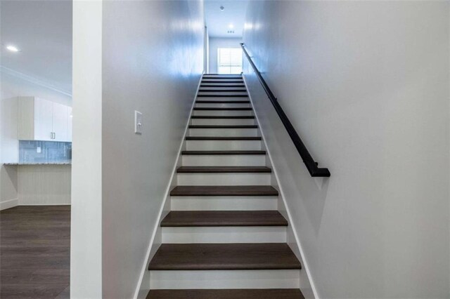 stairs featuring hardwood / wood-style floors