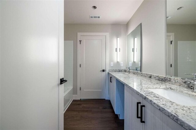 bathroom featuring vanity and hardwood / wood-style flooring