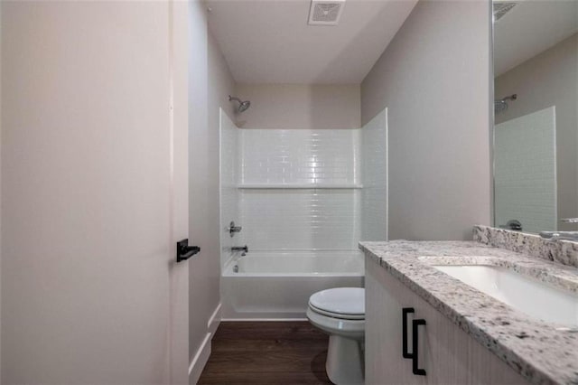 full bathroom with toilet, vanity, wood-type flooring, and tub / shower combination