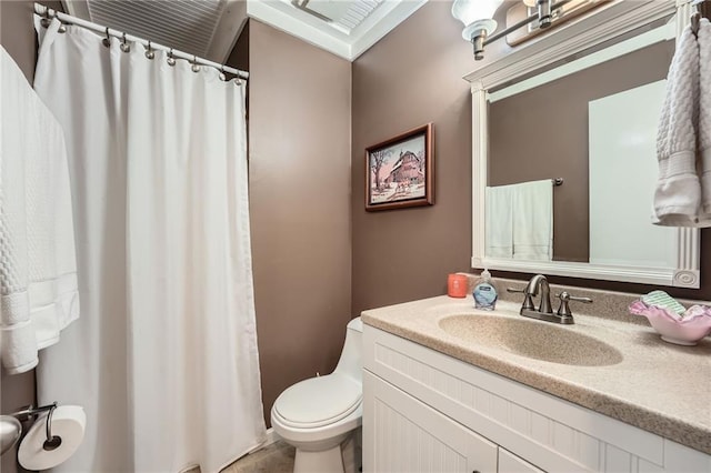 bathroom featuring toilet, vanity, and curtained shower