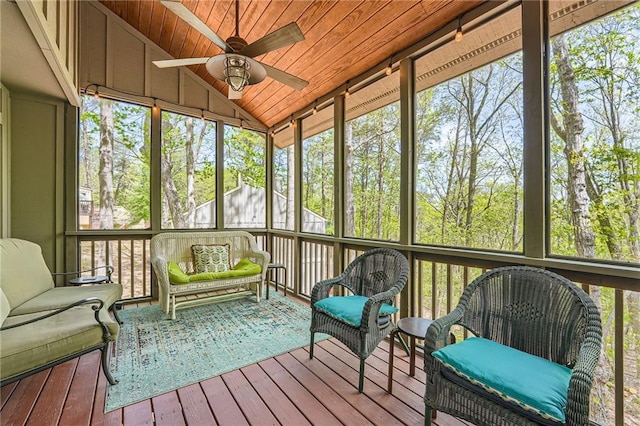 sunroom / solarium featuring plenty of natural light, an outdoor living space, and ceiling fan