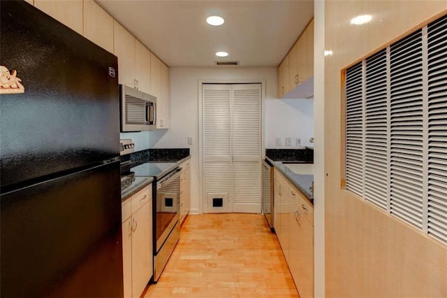 3481 Lakeside Dr NE Unit 902, Atlanta, GA 30326 - kitchen featuring appliances with stainless steel finishes, a heating unit, light wood-style flooring, and recessed lighting