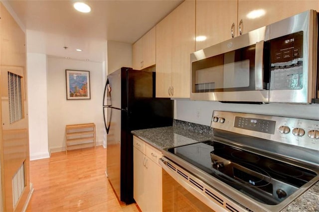 3481 Lakeside Dr NE Unit 902, Atlanta, GA 30326 - kitchen with stainless steel appliances, light wood-style flooring, recessed lighting, a heating unit, and dark stone countertops