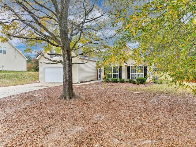 view of property hidden behind natural elements featuring a garage