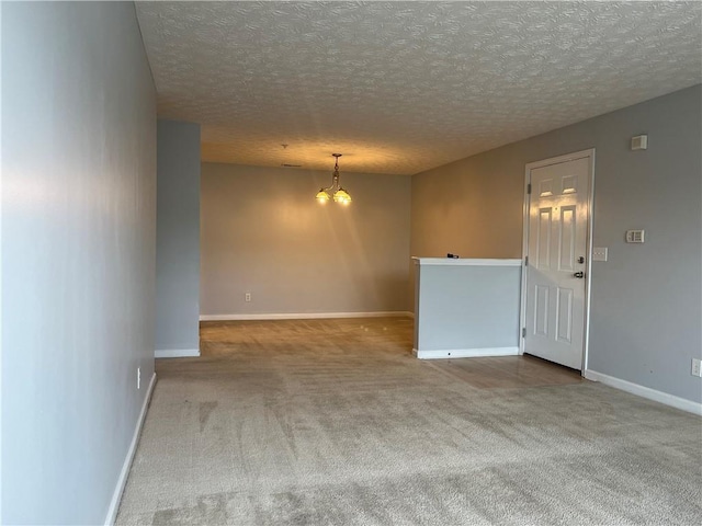 17301 Waldrop Cv, Decatur, GA 30034 - unfurnished room with a chandelier, carpet floors, baseboards, and a textured ceiling