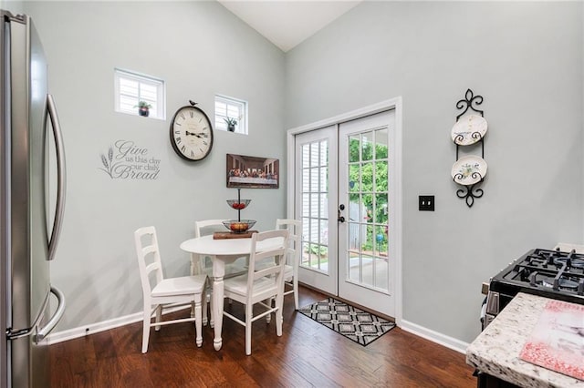 624 Spanish Oak Dr, Acworth, GA 30102 - dining area featuring french doors, dark wood-type flooring, baseboards, and a towering ceiling