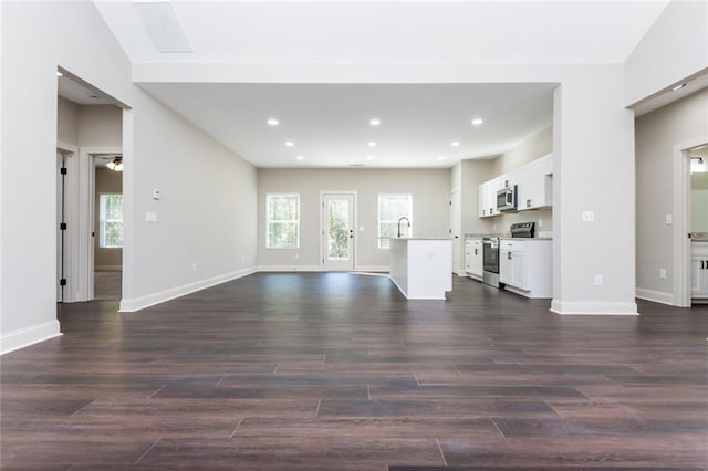 262 Stephens Rd, Cedartown, GA 30125 - unfurnished living room with dark wood-style flooring, baseboards, a sink, and recessed lighting