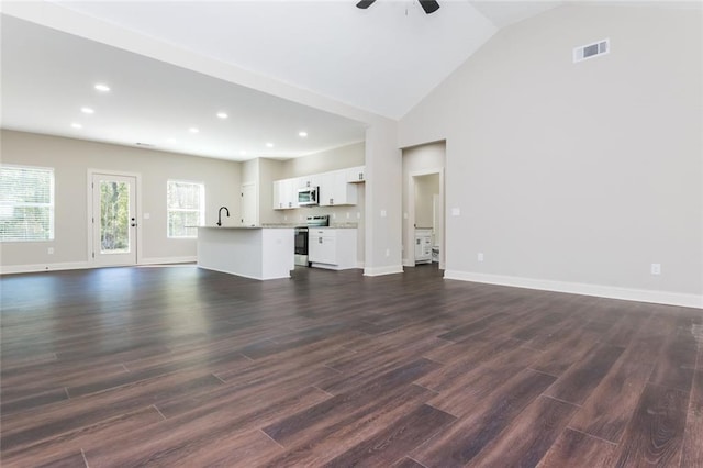 262 Stephens Rd, Cedartown, GA 30125 - unfurnished living room featuring dark wood-style floors, baseboards, recessed lighting, ceiling fan, and high vaulted ceiling