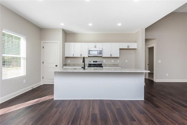 262 Stephens Rd, Cedartown, GA 30125 - kitchen featuring appliances with stainless steel finishes, baseboards, white cabinetry, an island with sink, and dark wood-style floors