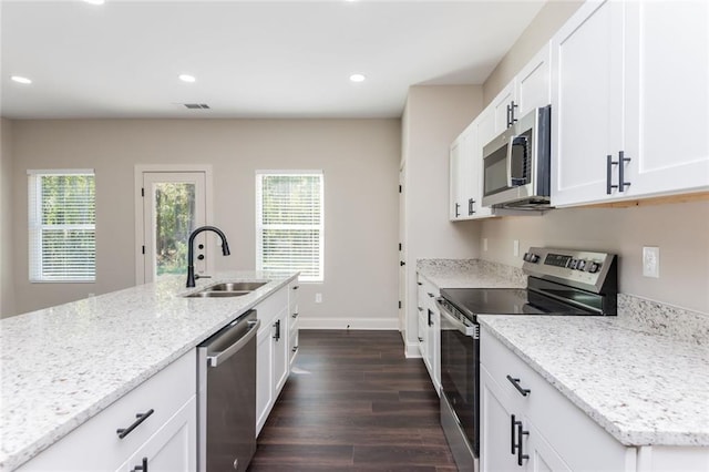 262 Stephens Rd, Cedartown, GA 30125 - kitchen featuring appliances with stainless steel finishes, healthy amount of natural light, dark wood-type flooring, light stone countertops, and recessed lighting