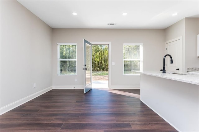 262 Stephens Rd, Cedartown, GA 30125 - doorway to outside with a sink, healthy amount of natural light, recessed lighting, dark wood-style floors, and baseboards