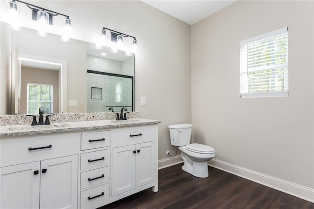 262 Stephens Rd, Cedartown, GA 30125 - full bath featuring toilet, double vanity, baseboards, a shower stall, and wood finished floors