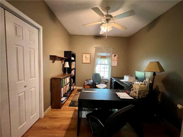 home office featuring ceiling fan, light wood-type flooring, and baseboards