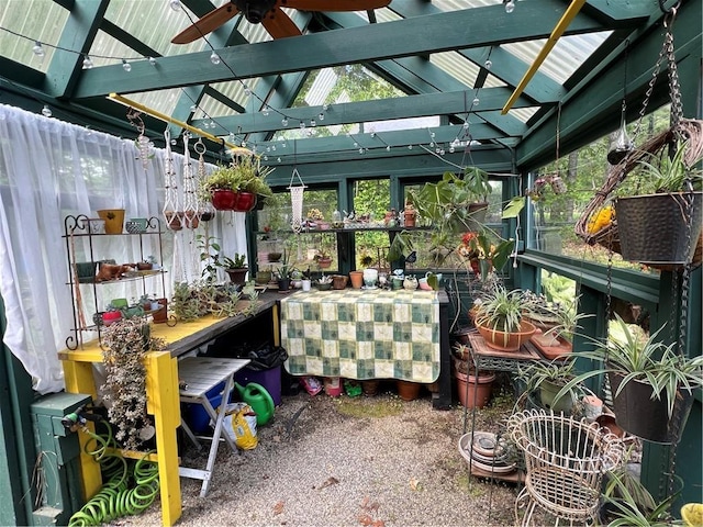 sunroom with a ceiling fan and vaulted ceiling