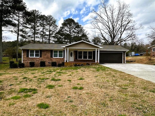 single story home featuring concrete driveway, an attached garage, a front yard, a porch, and brick siding