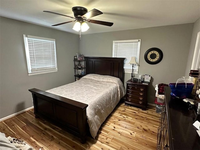 bedroom with light wood finished floors, ceiling fan, and baseboards