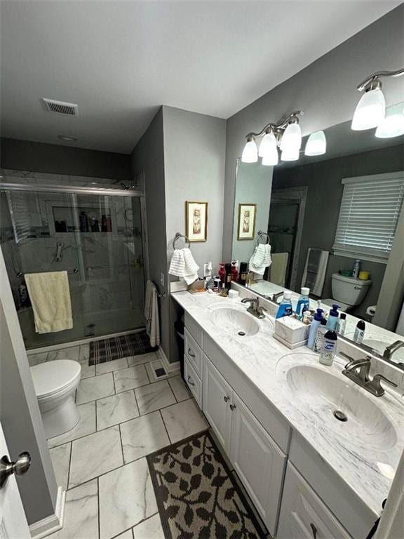 full bath with visible vents, a stall shower, a sink, and toilet