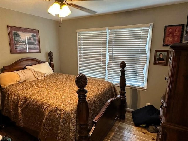 bedroom with a ceiling fan and wood finished floors