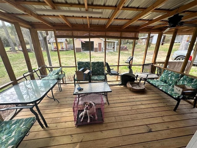 sunroom / solarium featuring ceiling fan