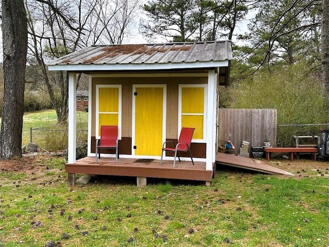 view of outdoor structure with an outbuilding and fence