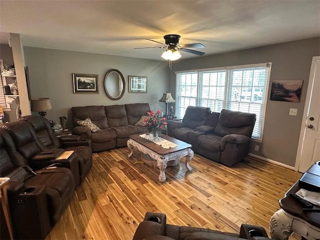 living area with light wood-type flooring and a ceiling fan