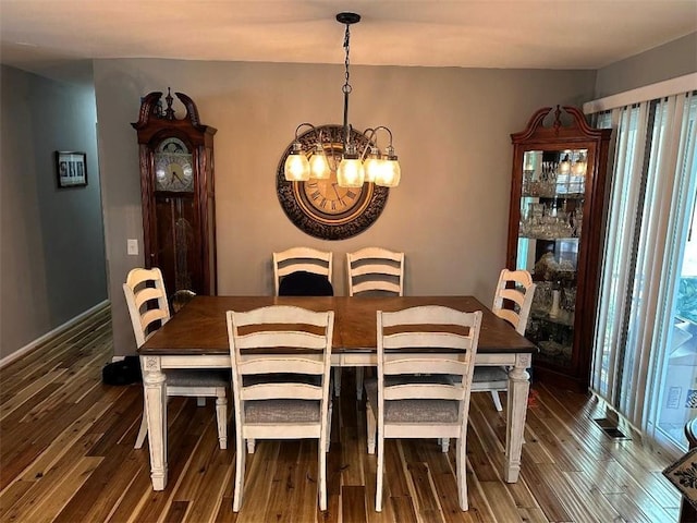 dining room featuring a chandelier and wood finished floors