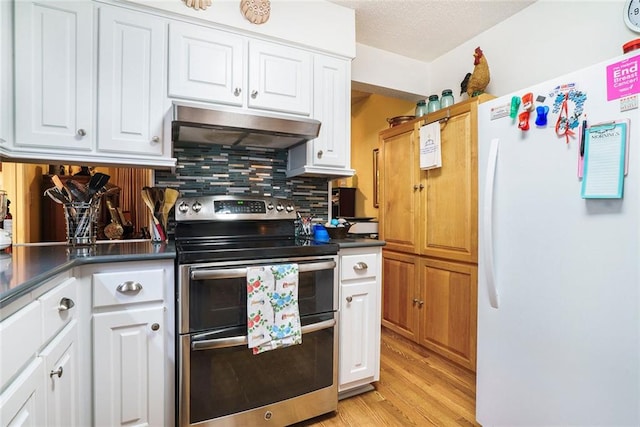 2505 Northlake Ct NE, Atlanta, GA 30345 - kitchen with freestanding refrigerator, double oven range, under cabinet range hood, decorative backsplash, and white cabinets