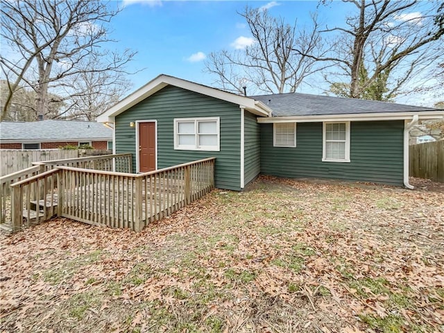 rear view of property with a wooden deck