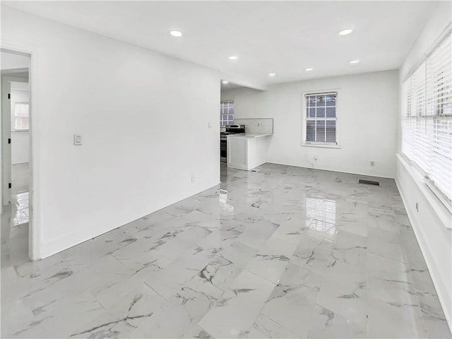 unfurnished living room with a wealth of natural light