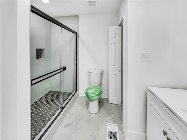 bathroom featuring toilet and walk in shower