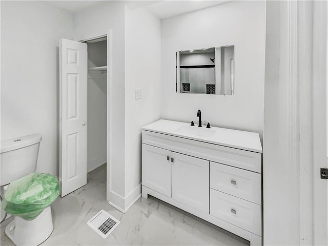 bathroom featuring vanity and toilet