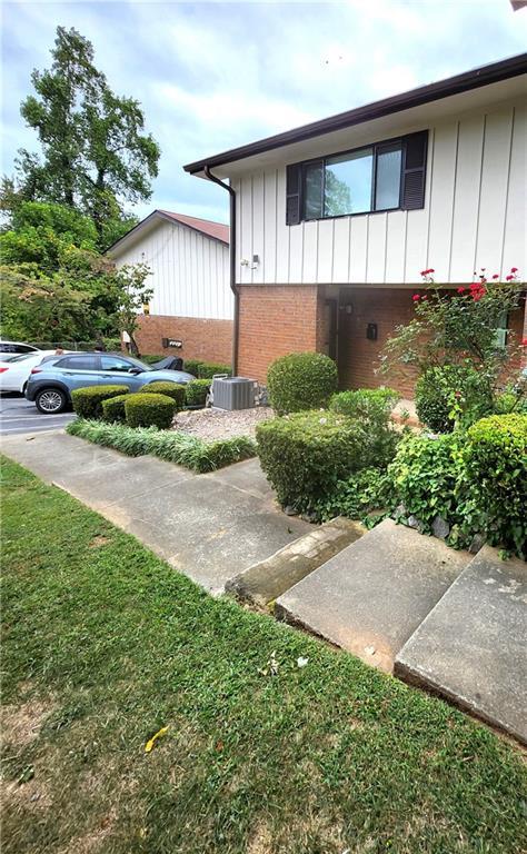 view of side of property with a lawn