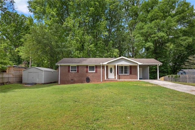 ranch-style home with concrete driveway, fence, a storage shed, and a front lawn
