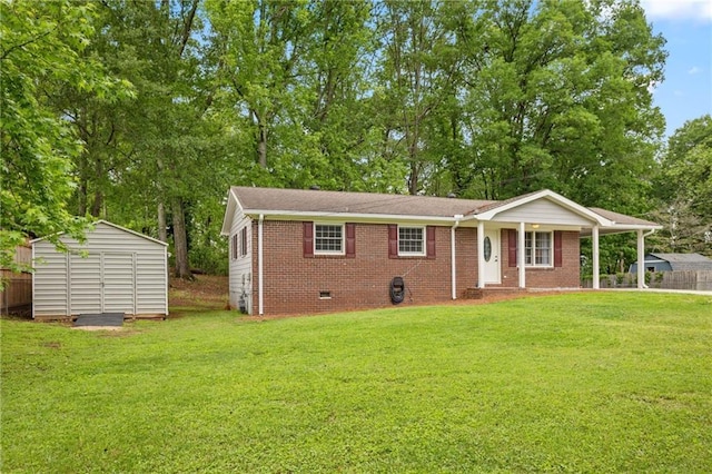 ranch-style home featuring a storage unit, a front lawn, fence, and crawl space