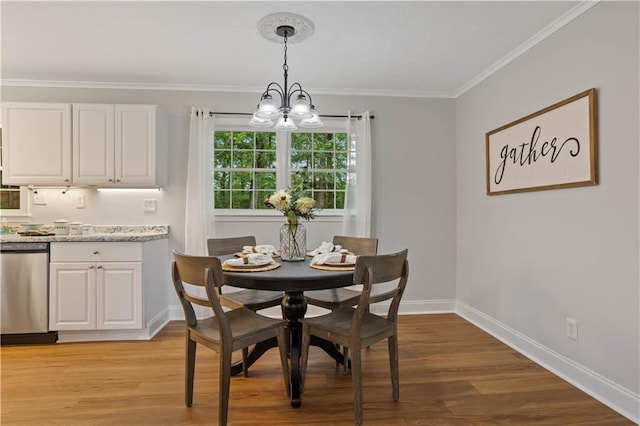 dining room with crown molding, baseboards, a chandelier, and light wood-type flooring