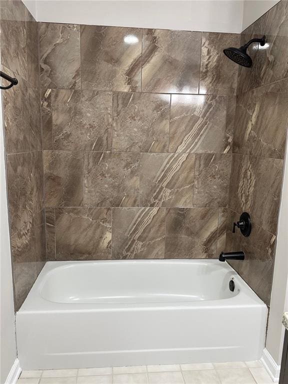 bathroom featuring tiled shower / bath combo and tile patterned flooring