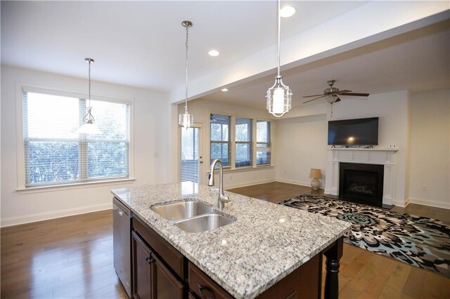 kitchen with dishwasher, sink, pendant lighting, and hardwood / wood-style flooring