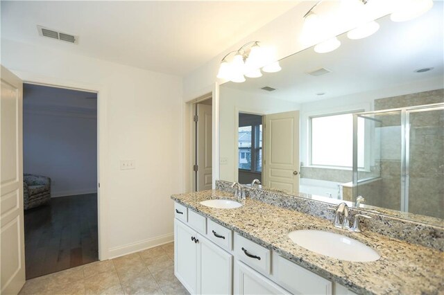 bathroom featuring vanity, shower with separate bathtub, and hardwood / wood-style flooring