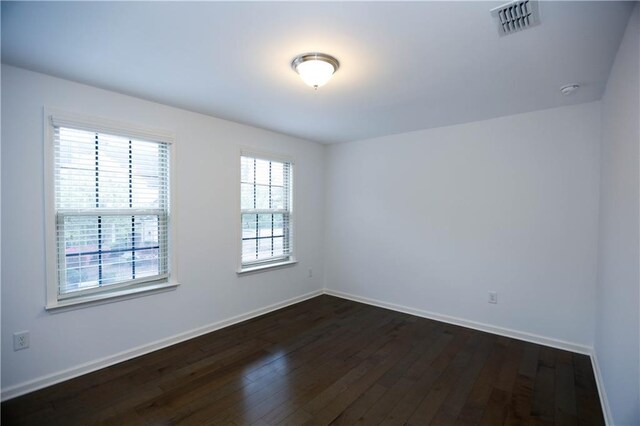 empty room with dark wood-type flooring